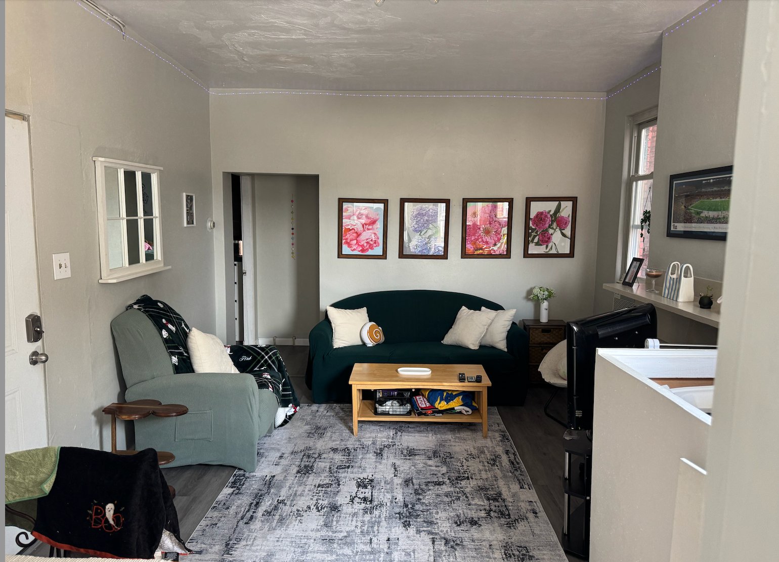 Comfortable living room at 358 Meyran #2 with a sofa, rug, and artwork